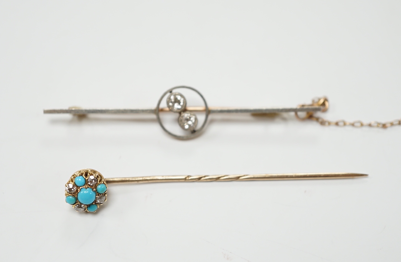 An early 20th century yellow metal, white metal and two stone diamond crossover set bar brooch, 57mm and a similar turquoise and diamond cluster set stick pin.